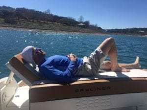 laying on the back of a boat sunning