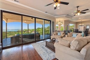 Beautiful rental house living room with view out to covered patio, and lovely view