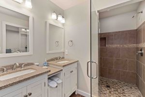 Rental House bathroom with double sinks, and walk-in shower